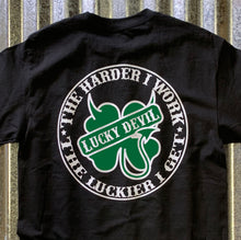 Load image into Gallery viewer, Lucky Devil &quot;The Harder I Work&quot; Black T-Shirt with Green and White.
