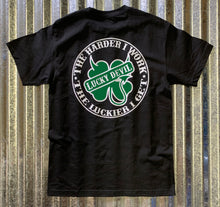 Load image into Gallery viewer, Lucky Devil &quot;The Harder I Work&quot; Black T-Shirt with Green and White.
