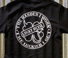 Load image into Gallery viewer, Lucky Devil &quot;The Harder I Work&quot; Black T-Shirt with White Logo.

